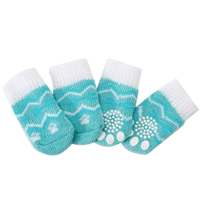 A set of four turquoise and white pet socks featuring a zigzag pattern and non-slip grips on the bottom.