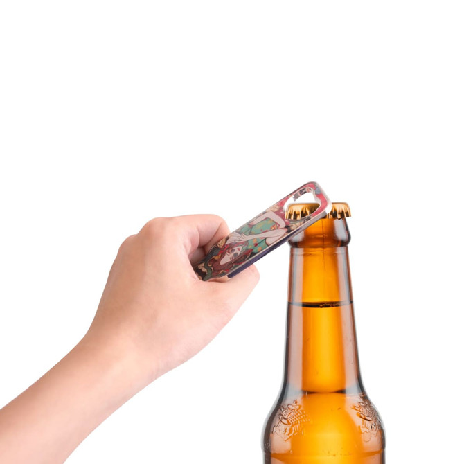 A drink bottle opener in a hand, designed as a fridge magnet, features a colourful pattern. It has a logo.