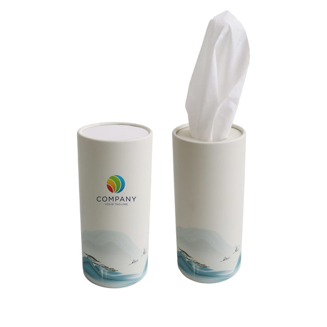 A cylindrical tissue dispenser in white with a scenic design and a logo on the front, holding a tissue.