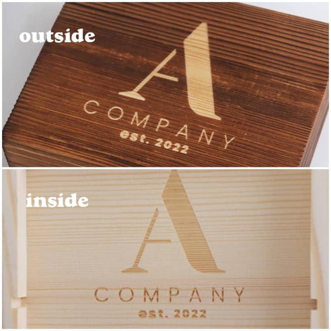 A wooden box with a logo, featuring a smooth, light-coloured interior and a darker exterior.