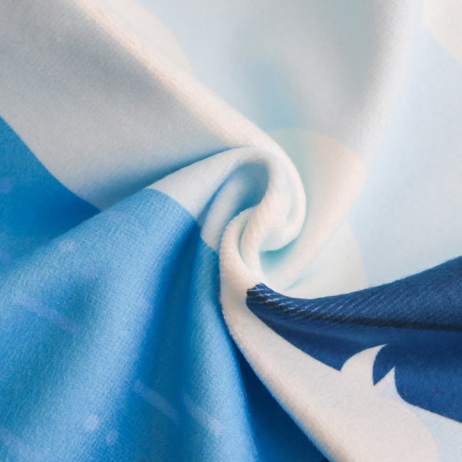 A microfibre beach towel in shades of blue, showcasing a smooth and soft texture. It features a logo.
