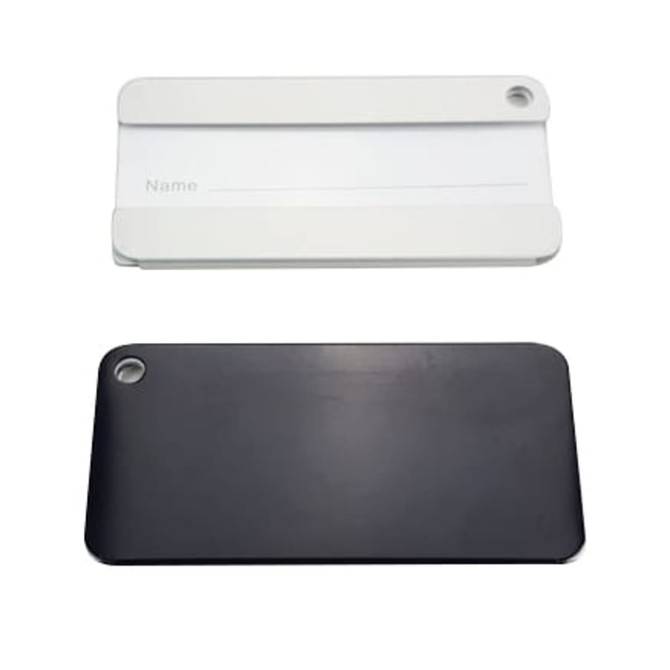 A square aluminium luggage tag in black and white, featuring a hole for attachment and a blank name section.
