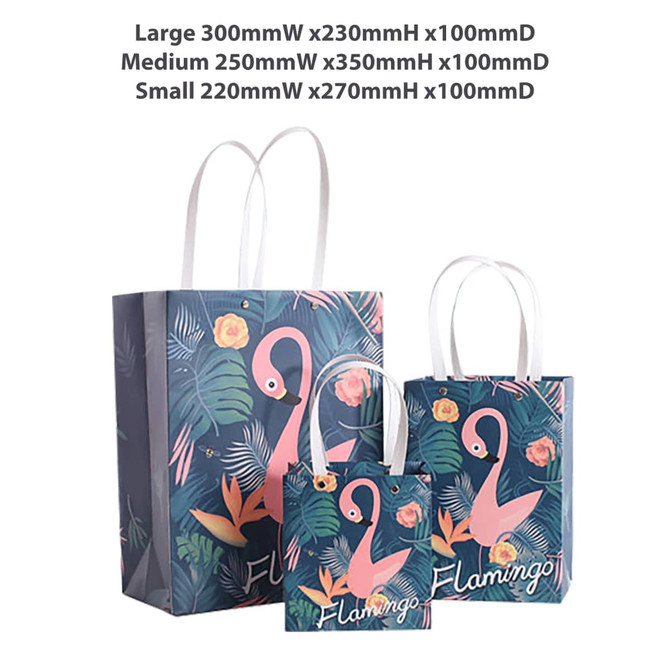 A collection of three decorative bags featuring a flamingo design and tropical leaves, with varying sizes and white handles.