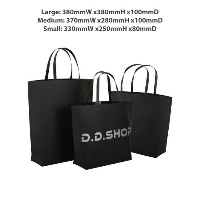 A large black boutique paper bag with two handles, featuring a logo and dimensions of 380 x 380 x 100mm.