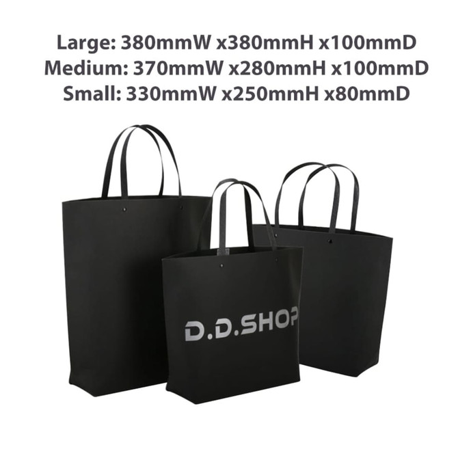 A large black and white boutique paper bag with two smaller bags, featuring a logo. Dimensions: 380 x 380 x 100mm.