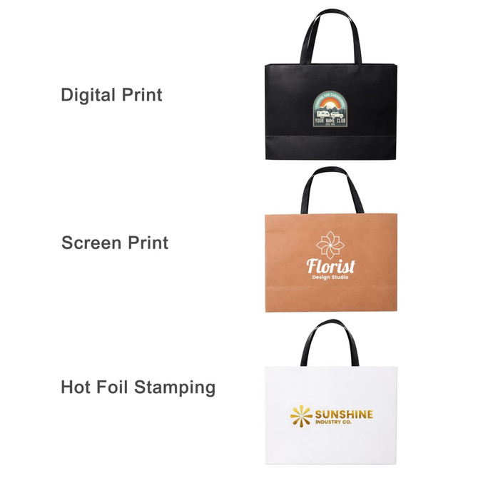 Three large paper bags with flat handles in black, brown, and white, featuring different print designs and a logo.