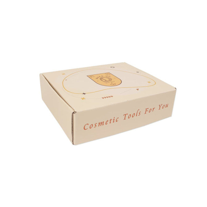 A cream-coloured subscription box featuring a decorative design and a logo, labelled for cosmetic tools.