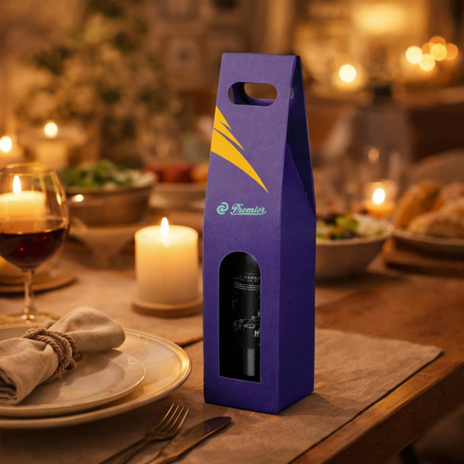 A purple portable wine box with a clear window showcasing a wine bottle, set on a dining table with candles and food.