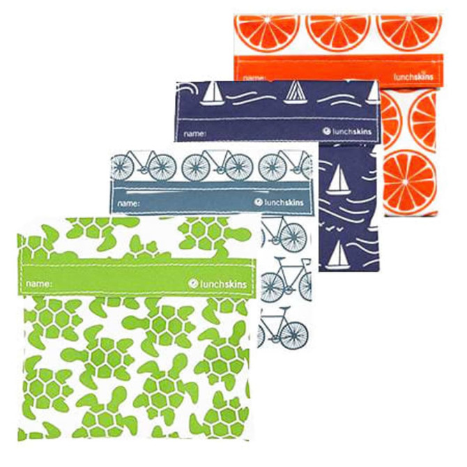 Four reusable food pouches featuring various designs, including orange slices, bicycles, turtles, and sailboats, with Velcro closures.