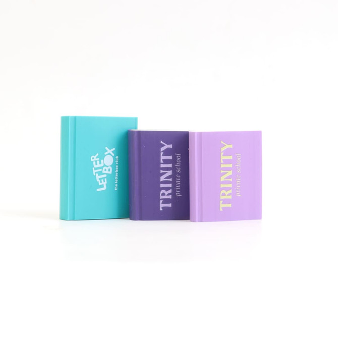 Three custom shape TPR erasers in turquoise, purple, and lavender, featuring various branding on the front.