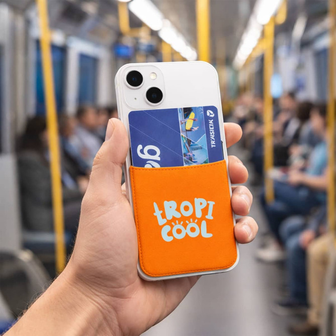 An orange Lycra Smart Wallet attached to a phone, holding a card, with a blurred background of a train interior.