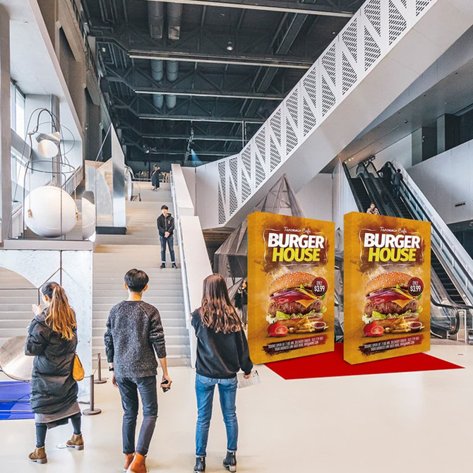 Two large, vibrant promotional displays with a burger design in a modern indoor venue.