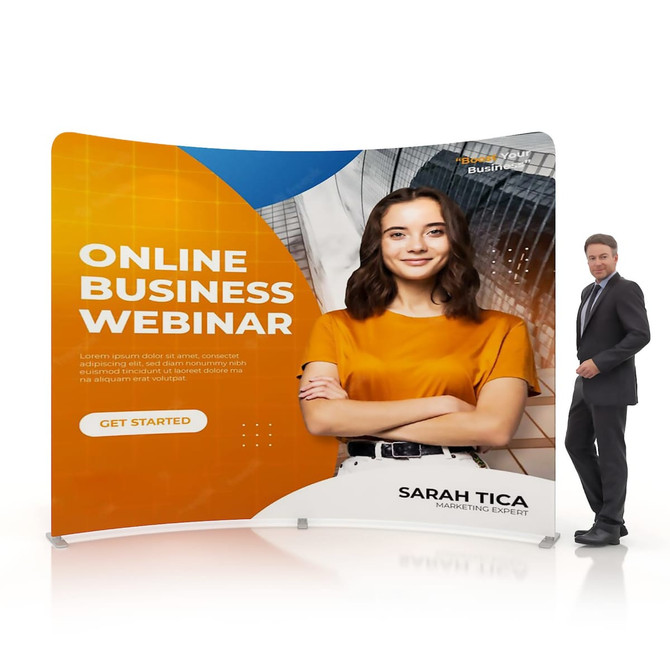 A C-shaped tension fabric display wall featuring vibrant orange and white colours, with a person and a woman in an orange shirt.