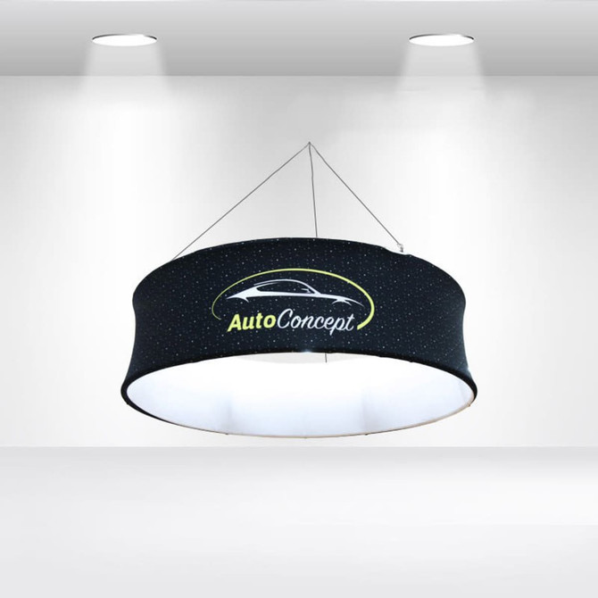 A round hanging banner in black with a logo, illuminated from within, featuring a starry design.