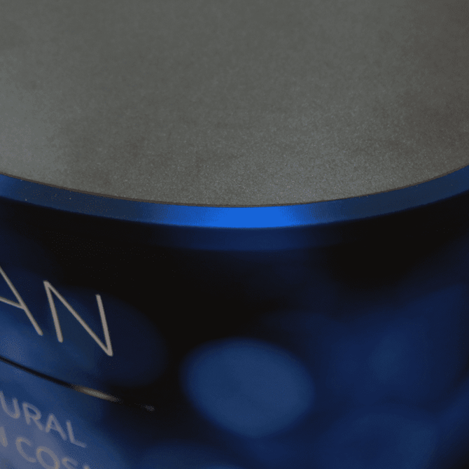 A blue oval popup booth with a smooth, dark top surface, featuring an abstract design.