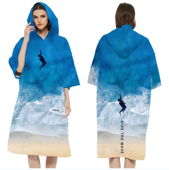 A hooded change towel in blue featuring a beach and wave design, with a logo on the front.
