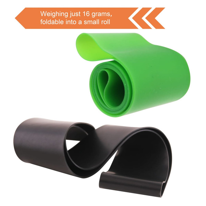 A green and black latex-free TPE fitness resistance band, rolled into a compact shape for easy storage.
