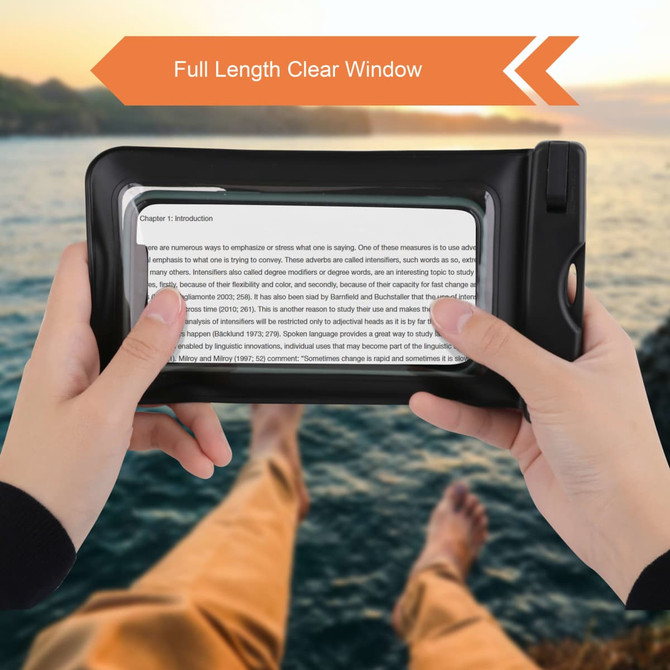 A waterproof phone bag with a full-length clear window, black in colour, held by two hands against a scenic background.