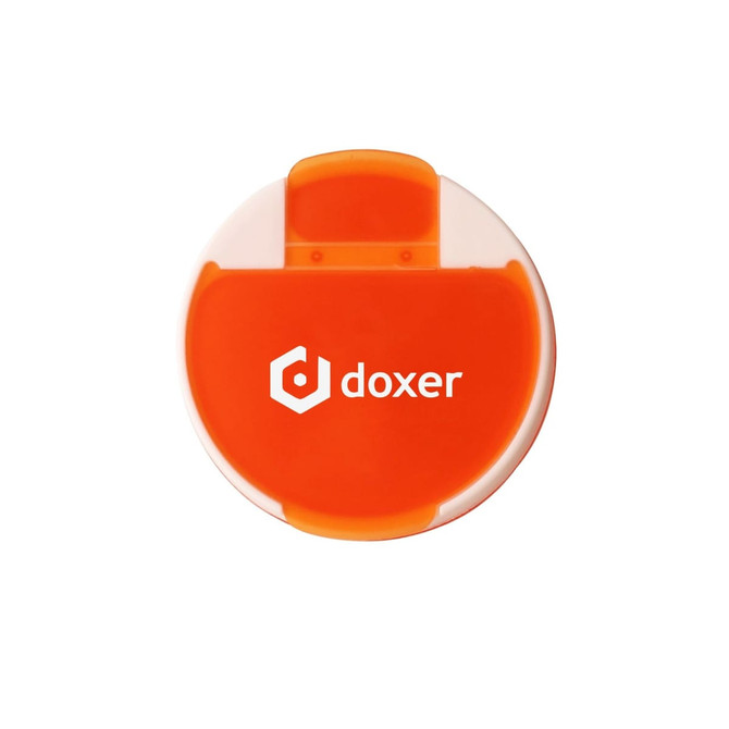 A round pill box in orange and white with a logo on the front.