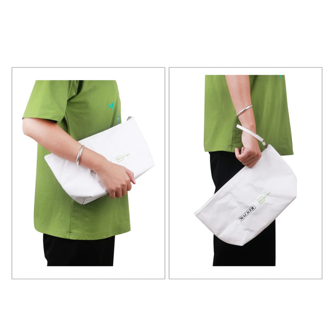 A washable kraft paper cosmetic bag in white, held by a person wearing a green shirt, featuring a logo.