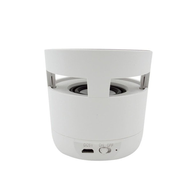 A white cylindrical Bluetooth speaker with a wireless charging base, featuring a USB port and an on/off switch.