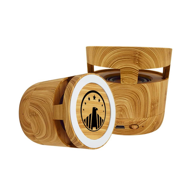 A bamboo Bluetooth speaker with a wireless charging feature, showcasing a circular design and a logo on the front.