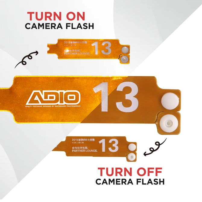 A collection of orange reflective PVC wristbands, featuring white buttons and a logo.