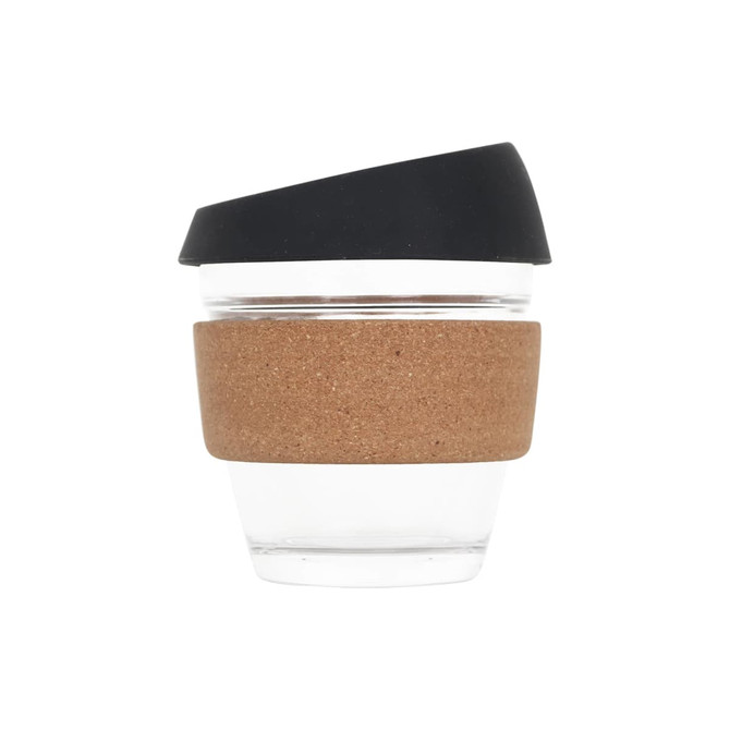 A reusable glass coffee cup with a cork band and a black lid, featuring a clear glass body.