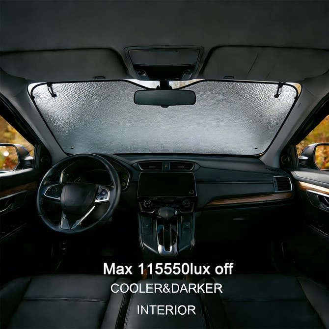 A bubble aluminium car sunshade in silver, fitted inside a car, blocking sunlight from the front windshield.