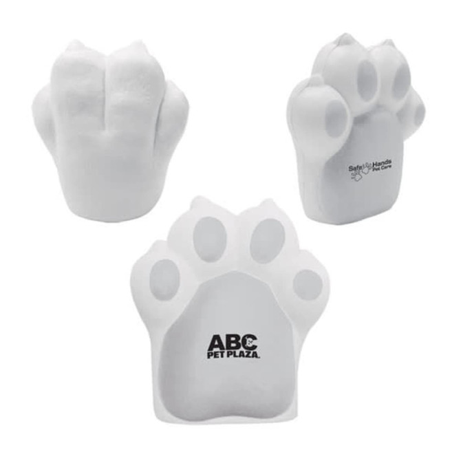 A dog paw-shaped stress reliever in white, featuring a logo on one side.
