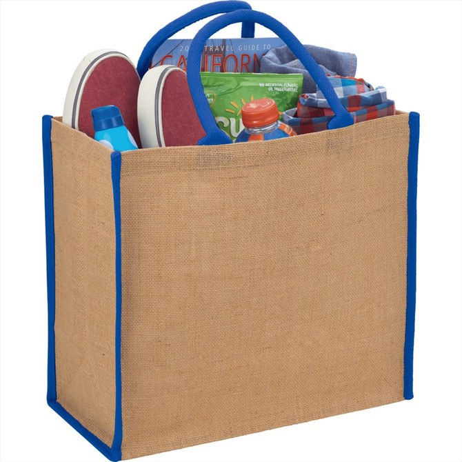 A large jute tote in natural and blue, filled with shoes, a drink bottle, and clothing items.