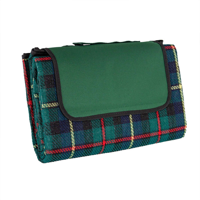 A picnic rug in green with a tartan pattern featuring red, blue, and yellow lines. Includes a logo.