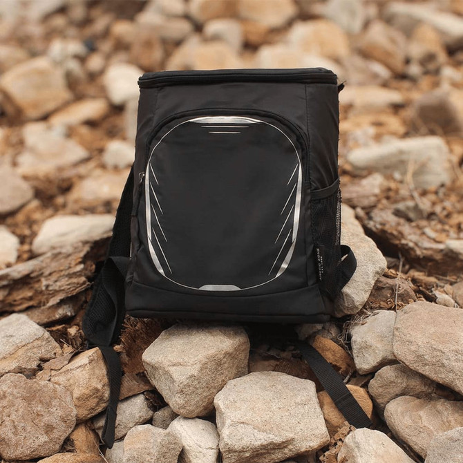 A black cooler backpack with a front pocket and mesh side pockets, set against a rocky background.