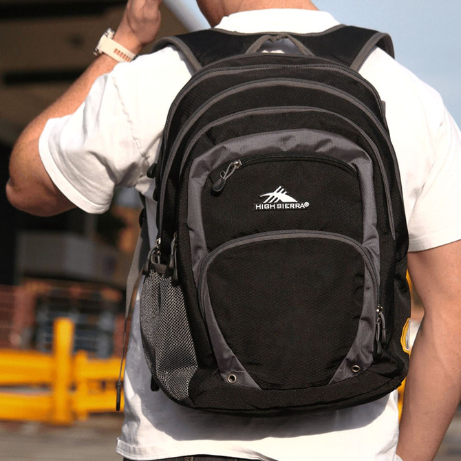 A black and grey backpack with multiple compartments and a side mesh pocket, featuring a logo on the front.