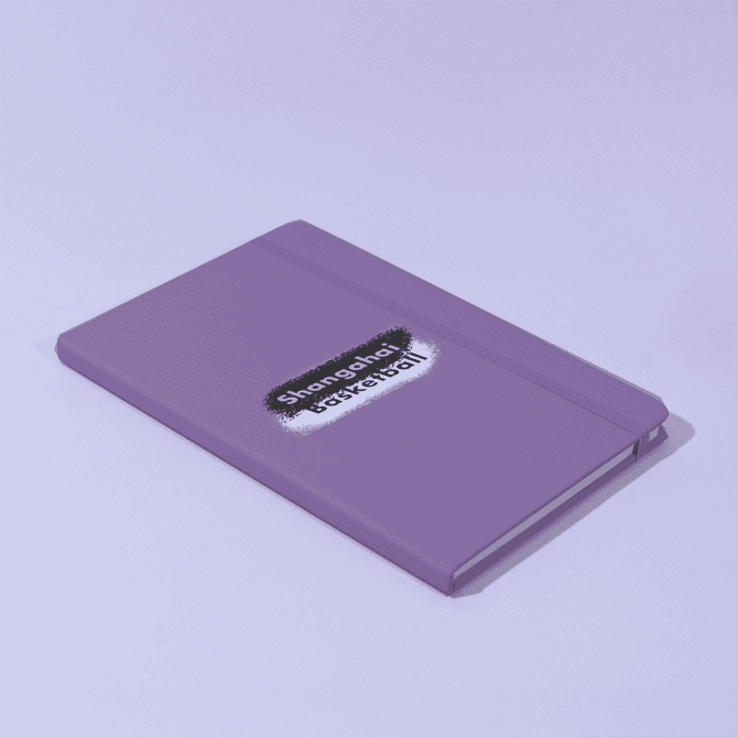 A purple A5 notebook with a logo on the cover, featuring a matching elastic band closure.