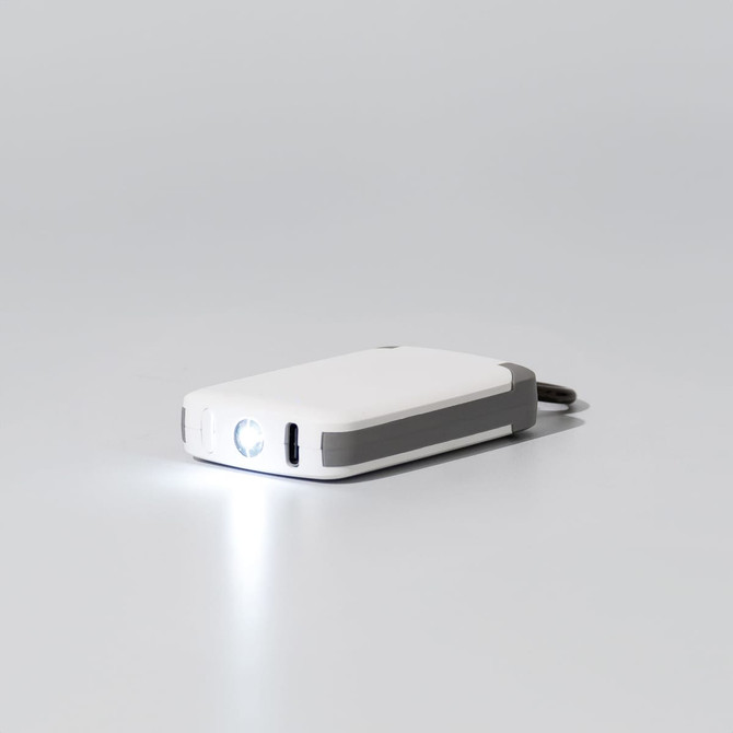 A white and grey mini power bank with a built-in flashlight. It has a logo on the surface.