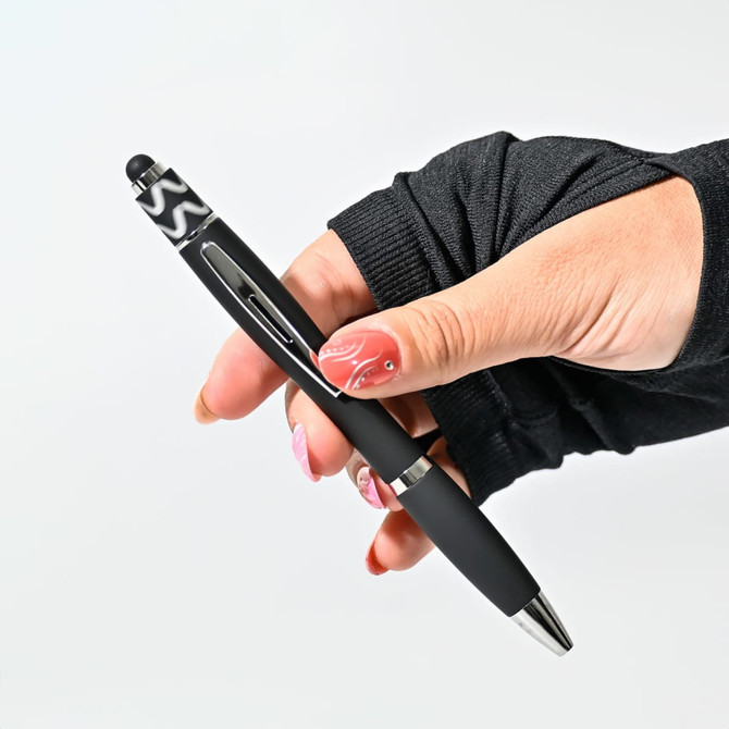 A black Spinner Fidget Pen held in a hand, featuring a stylus tip and an ergonomic design.