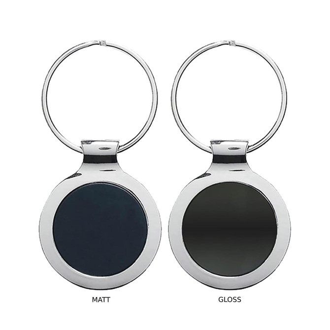 A keyring featuring a round metal design in glossy and matte finishes, with a silver ring attachment.