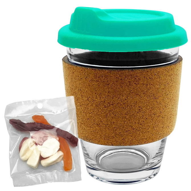A glass coffee cup with a cork band and a teal lid, accompanied by a pack of mixed lollies in various colours.