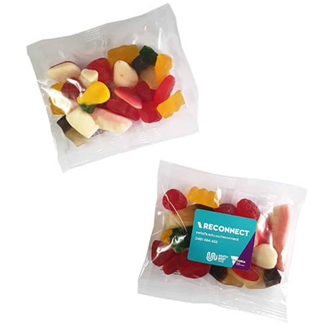 A clear bag of mixed lollies featuring various shapes and vibrant colours, including reds, yellows, and whites.