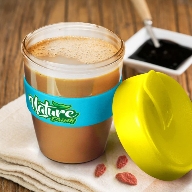 A drink bottle with a yellow lid and a blue sleeve, containing a brown beverage, placed on a textured surface.