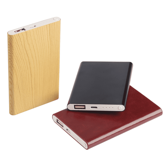 A collection of three powerbanks in wood, black, and burgundy finishes, each featuring a logo.