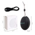 A portable black waterproof Bluetooth speaker with a microphone, accompanied by a USB charging cable and box.