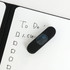 A5 whiteboard notebook with a black cover and a dark blue eraser on a handwritten to-do list.