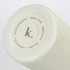 A drink bottle in a soft cream colour with a round base featuring a logo and care instructions.