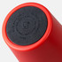A red coffee cup with a round black base, featuring a logo and instructions for use.