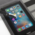 A smartphone with a stylus placed on a black tech organiser featuring grey stitching and multiple slots.