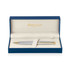 A brushed stainless steel ballpoint pen with gold accents, presented in a blue gift box with a cream interior.
