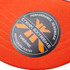 An orange trucker cap featuring a circular logo on the front. The cap is made from recycled polyester.