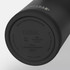 A drink bottle in matte black with a stainless steel bottom, featuring a logo on its underside.